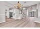 Open concept living area features hardwood floors, modern kitchen, and elegant staircase at 3088 Via Flaminia Ct, Henderson, NV 89052