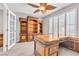 Office space featuring custom wood built-ins, plush carpet, and bright windows at 3088 Via Flaminia Ct, Henderson, NV 89052