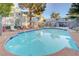Community pool with lounge chairs surrounded by mature trees and shrubbery at 3823 S Maryland Pkwy # T8, Las Vegas, NV 89119