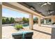 Covered backyard with pool, water feature, and ample seating at 39 Coralwood Dr, Las Vegas, NV 89135