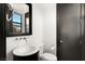 Sleek bathroom featuring a modern sink, toilet, and dark wood accents at 39 Coralwood Dr, Las Vegas, NV 89135