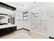 Modern bathroom featuring a glass-enclosed shower, soaking tub, and dual sink vanity at 39 Coralwood Dr, Las Vegas, NV 89135