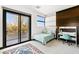 Cozy bedroom with private balcony access, wood accent wall, and a desk at 39 Coralwood Dr, Las Vegas, NV 89135