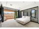 Airy bedroom featuring a private balcony with desert views, elegant decor, and a modern design at 39 Coralwood Dr, Las Vegas, NV 89135