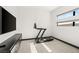 Exercise room featuring a treadmill, TV, storage, and a bright window at 39 Coralwood Dr, Las Vegas, NV 89135