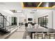 Open-concept living area with a fireplace, modern furnishings, and stairs to a stylish mezzanine level at 39 Coralwood Dr, Las Vegas, NV 89135