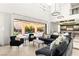 Sophisticated living room with plush seating, elegant lighting, and access to a private outdoor pool area at 39 Coralwood Dr, Las Vegas, NV 89135
