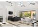 Bright living area with a fireplace, comfortable seating, and sliding glass doors that open to the patio at 39 Coralwood Dr, Las Vegas, NV 89135