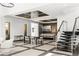 Bright, open living space with modern decor, sleek staircase, and seamless flow to the dining and kitchen areas at 39 Coralwood Dr, Las Vegas, NV 89135