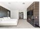 Spacious main bedroom boasts a sleek fireplace, TV, modern grid wall, and comfortable furnishings at 39 Coralwood Dr, Las Vegas, NV 89135