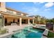 Backyard featuring large in-ground swimming pool with fountains, as well as a covered seating area at 39 Coralwood Dr, Las Vegas, NV 89135