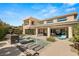 An attractive view of the home's backyard pool with integrated water features and patio sitting area at 39 Coralwood Dr, Las Vegas, NV 89135