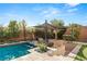 Backyard pool with attached bar seating, in-ground BBQ area, and shaded dining space at 39 Coralwood Dr, Las Vegas, NV 89135
