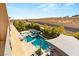An aerial view of the backyard pool and spa area, showcasing the landscaping and shaded lounge area at 39 Coralwood Dr, Las Vegas, NV 89135