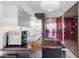 Modern kitchen featuring stainless steel appliances and dark wood breakfast bar with seating at 4381 W Flamingo Rd # 38303, Las Vegas, NV 89103
