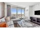 Bright living room with expansive city views, a comfortable sectional sofa, and modern decor at 4381 W Flamingo Rd # 38303, Las Vegas, NV 89103