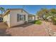 A backyard view features desert landscaping, a covered patio, and turf at 4956 Momenti St, Las Vegas, NV 89135