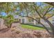 Well-maintained backyard featuring an artificial turf area, desert landscaping, and a covered patio at 4956 Momenti St, Las Vegas, NV 89135