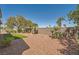 Backyard featuring desert landscaping and a stone retaining wall at 4956 Momenti St, Las Vegas, NV 89135