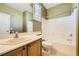 Bathroom featuring wood cabinets, laminate countertop, and combination shower and tub at 4956 Momenti St, Las Vegas, NV 89135