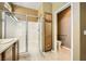 Bathroom featuring a glass-enclosed shower, wood cabinets, and a separate toilet area at 4956 Momenti St, Las Vegas, NV 89135