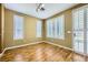 Bright bedroom featuring wood floors, windows with shutters, and access to the patio at 4956 Momenti St, Las Vegas, NV 89135