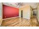 Spacious bedroom featuring wood floors, closet, and ceiling fan with light at 4956 Momenti St, Las Vegas, NV 89135