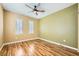 Spacious bedroom features hardwood floors, neutral walls, and natural light from shuttered windows at 4956 Momenti St, Las Vegas, NV 89135