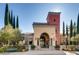 A Tuscan style clubhouse with a tower and landscaped entrance at 4956 Momenti St, Las Vegas, NV 89135