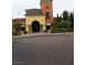 A Tuscan style clubhouse with a tower and landscaped entrance at 4956 Momenti St, Las Vegas, NV 89135