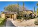 A Tuscan style clubhouse with a covered walkway and landscaped entrance at 4956 Momenti St, Las Vegas, NV 89135