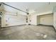Spacious garage with ample storage and a roll-up door at 4956 Momenti St, Las Vegas, NV 89135
