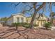 Inviting one-story home with desert landscaping and a two-car garage, set against a clear blue sky at 4956 Momenti St, Las Vegas, NV 89135