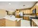 Well-equipped kitchen with stainless steel appliances, ample counter space, and light wood cabinetry at 4956 Momenti St, Las Vegas, NV 89135