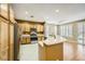 Well-lit kitchen with wooden cabinets, stainless steel appliances, breakfast bar, and tiled flooring at 4956 Momenti St, Las Vegas, NV 89135