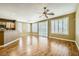Open living room with wood floors, shutters, and a breakfast bar area to the side at 4956 Momenti St, Las Vegas, NV 89135