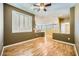 Living room with wood floors and large window with plantation shutters at 4956 Momenti St, Las Vegas, NV 89135