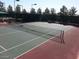 An outdoor tennis court with a net and visible court lines, ready for a match at 4956 Momenti St, Las Vegas, NV 89135