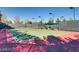 An outdoor tennis court with a net and visible court lines, ready for a match at 4956 Momenti St, Las Vegas, NV 89135