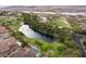 Stunning aerial view of a luxury community featuring a lake, golf course, and upscale homes against a mountain backdrop at 5 Circa De Montanas, Henderson, NV 89011