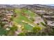 Expansive aerial view of a golf course surrounded by luxury homes nestled against a mountainous landscape at 5 Circa De Montanas, Henderson, NV 89011