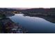 An aerial view of luxury homes along the tranquil lake with private docks at twilight, showcasing upscale living at 5 Circa De Montanas, Henderson, NV 89011
