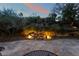 A landscaped backyard featuring stone flooring, a landscaped garden with rocks and outdoor lighting at 5 Circa De Montanas, Henderson, NV 89011