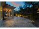 Backyard patio featuring stone flooring, architectural pillars, and professionally landscaped garden at 5 Circa De Montanas, Henderson, NV 89011
