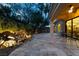 Backyard patio featuring stone flooring, architectural pillars, and professionally landscaped garden with waterfall feature at 5 Circa De Montanas, Henderson, NV 89011