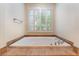 Bright bathroom featuring a built in tub with tile surround and window with plantation shutters at 5 Circa De Montanas, Henderson, NV 89011