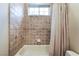 Bathroom showcasing tiled bathtub, window and neutral color palette at 5 Circa De Montanas, Henderson, NV 89011