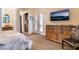 Bedroom featuring a dresser, TV, and doors to the backyard, offering a cozy retreat at 5 Circa De Montanas, Henderson, NV 89011