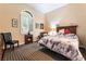 Bedroom with a decorative bed, cozy seating area, and ample natural light from the window at 5 Circa De Montanas, Henderson, NV 89011