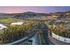 Scenic view of Lake Las Vegas entrance with golf course, palm trees and mountain backdrop, under a vibrant sky at 5 Circa De Montanas, Henderson, NV 89011